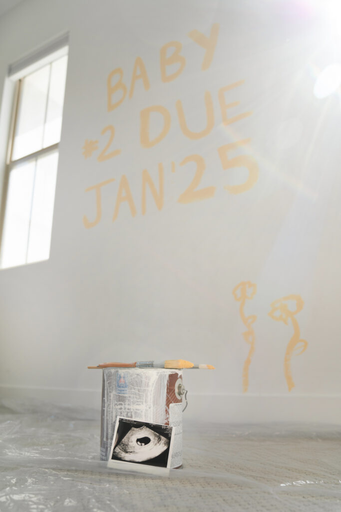 Jessa Jones' baby announcement with ultrasound photo and painted writing on the wall. Baby number 2 due January 2025