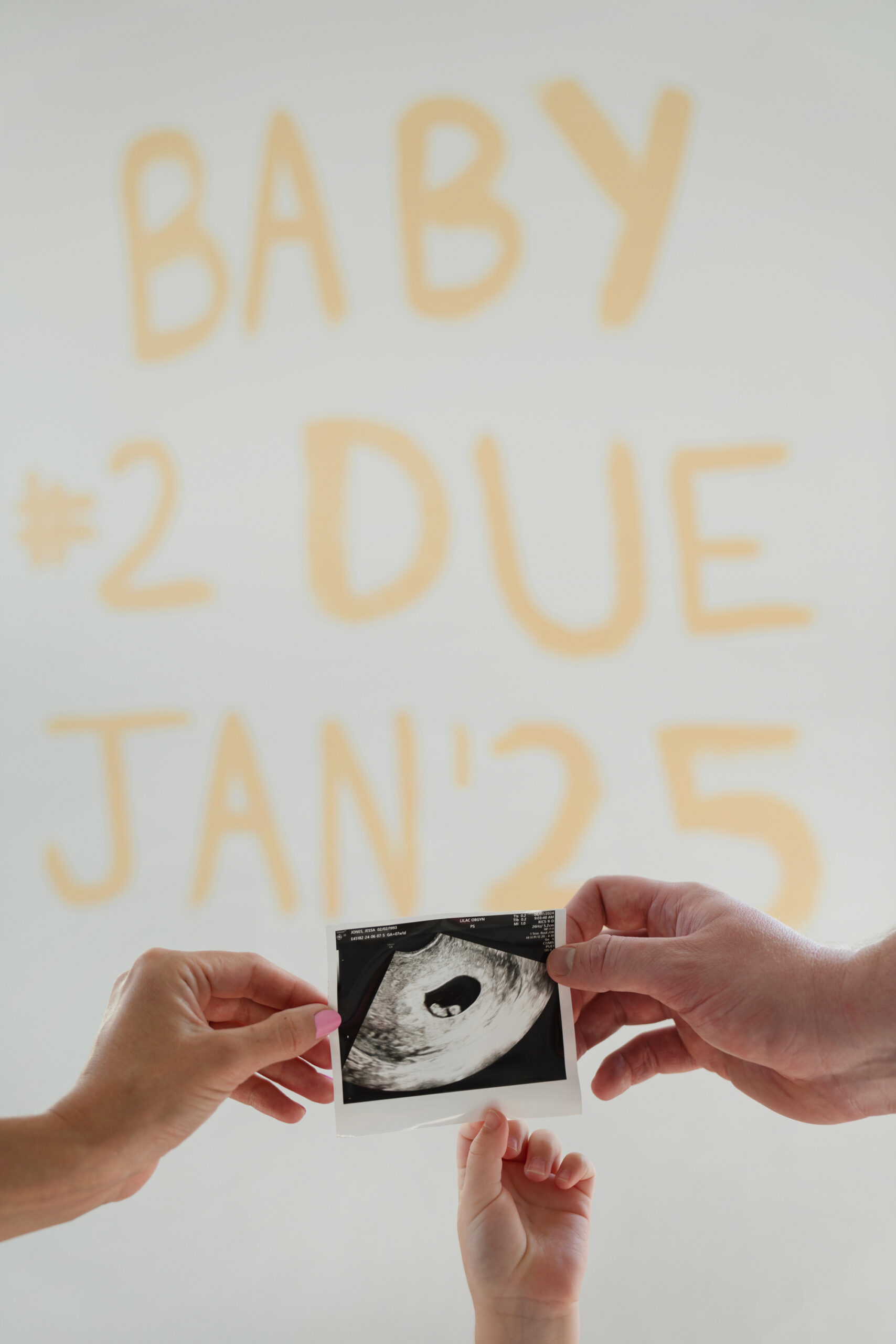 Jessa Jones' baby announcement with hands holding an ultrasound photo.